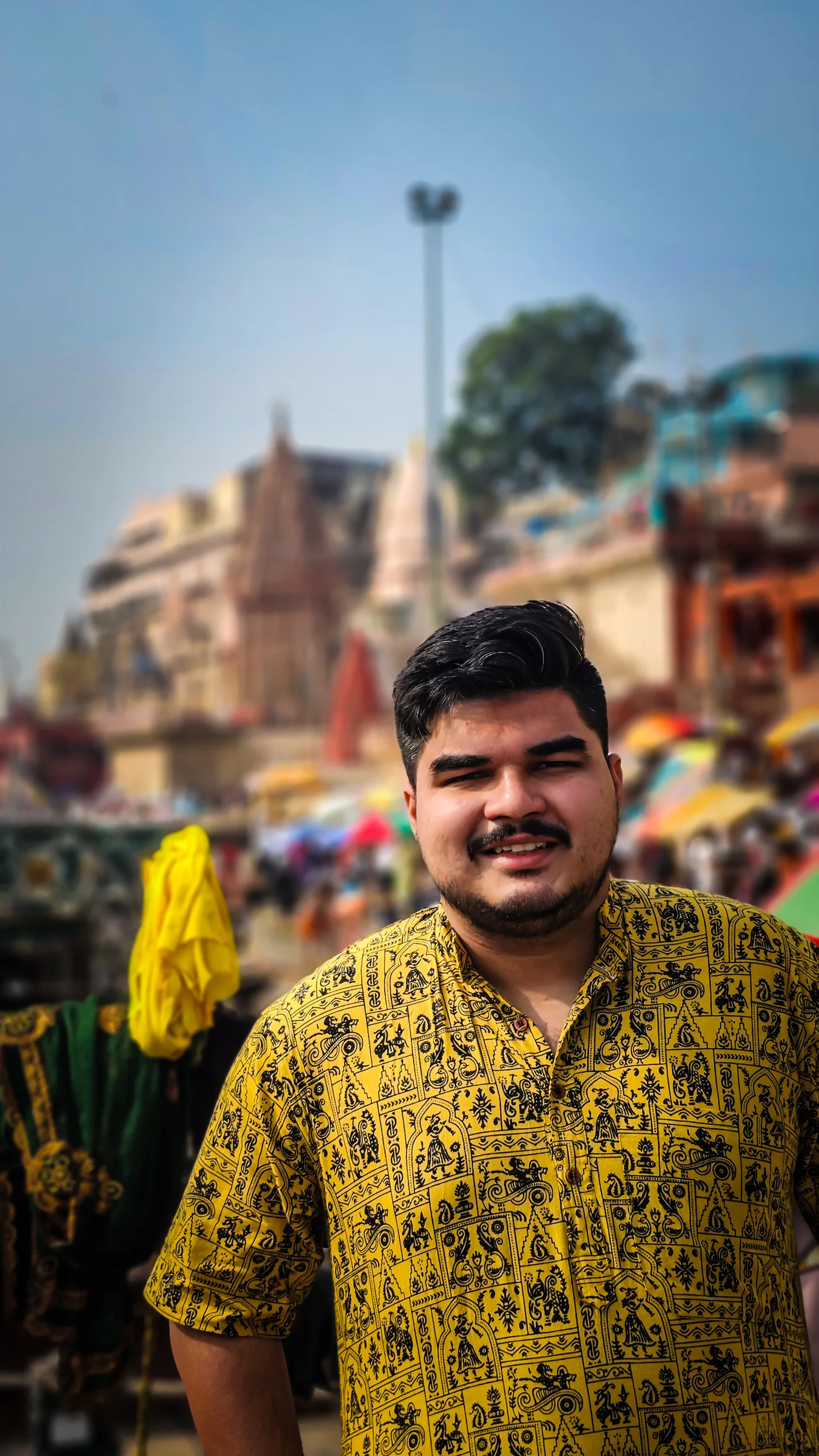 Shubhankar in a yellow patterned shirt beside a riverside setting